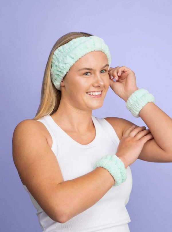 Girl wearing mint skincare headband in turban style and matching green face washing wrist towels