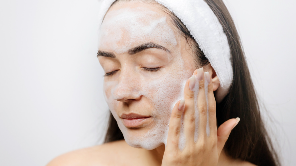 woman face washing with foam cleanser